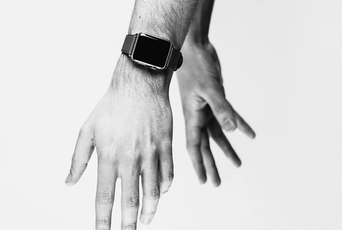 A smartwatch worn on a wrist, hands relaxed and empty.